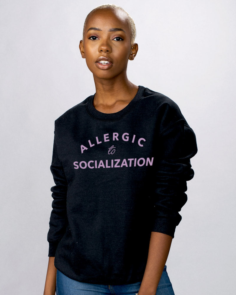 Allergic To Socialization Sweatshirt - Femfetti - A black unisex fit graphic crewneck sweatshirt featuring the phrase &quot;Allergic to Socialization&quot; in purple text.