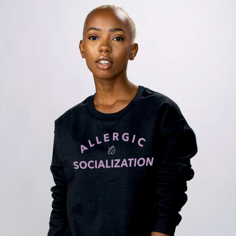 Allergic To Socialization Sweatshirt - Femfetti - A black unisex fit graphic crewneck sweatshirt featuring the phrase &quot;Allergic to Socialization&quot; in purple text.