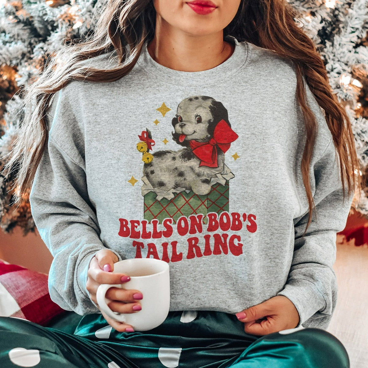 Bells on Bob&#39;s Tail Sweatshirt - Femfetti - A grey unisex fit graphic crewneck sweatshirt featuring the phrase &quot;Bells on Bob&#39;s Tail Ring&quot; with an image of a dog.