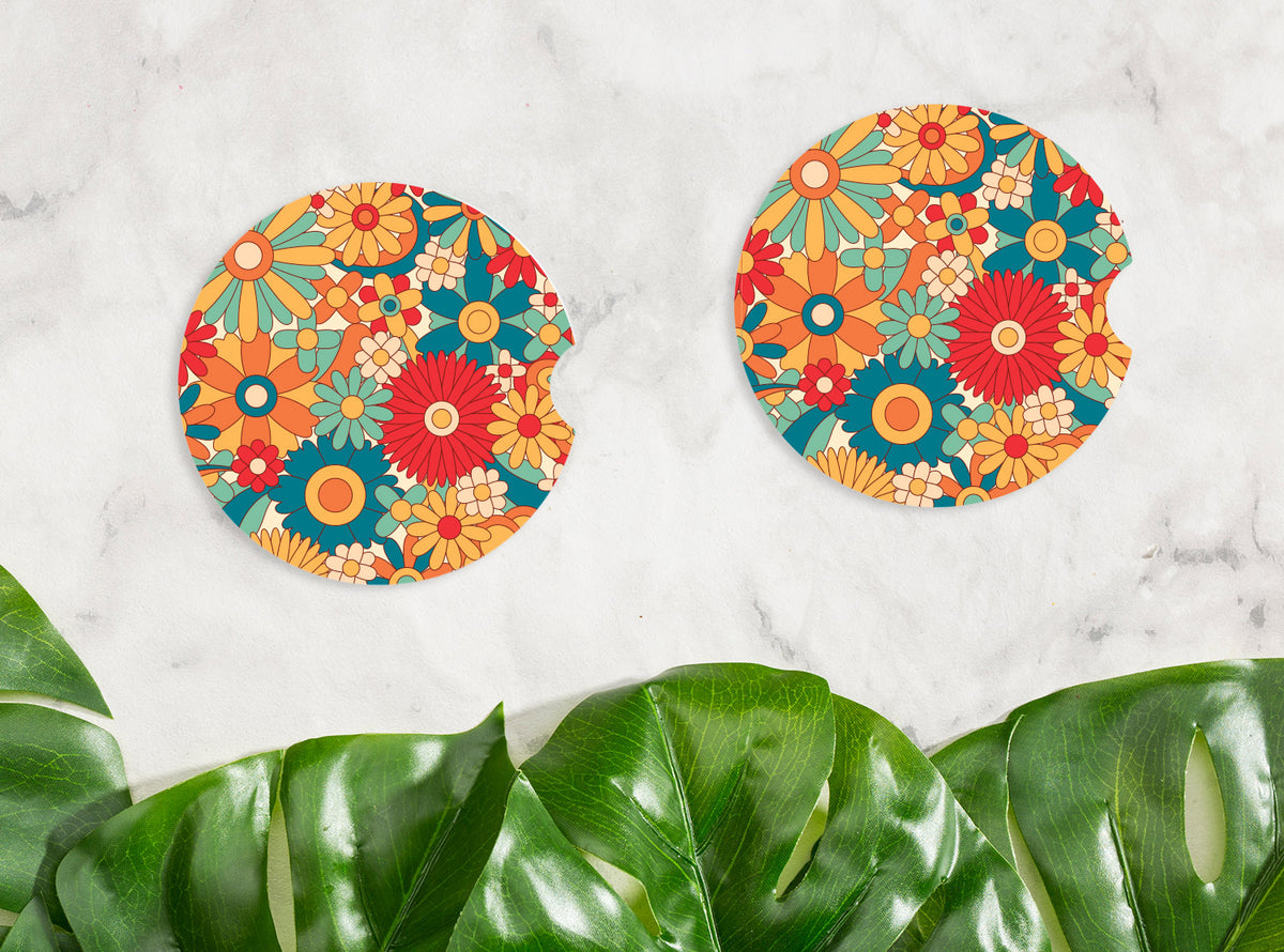 Two ceramic car coasters with a 70&#39;s floral pattern.