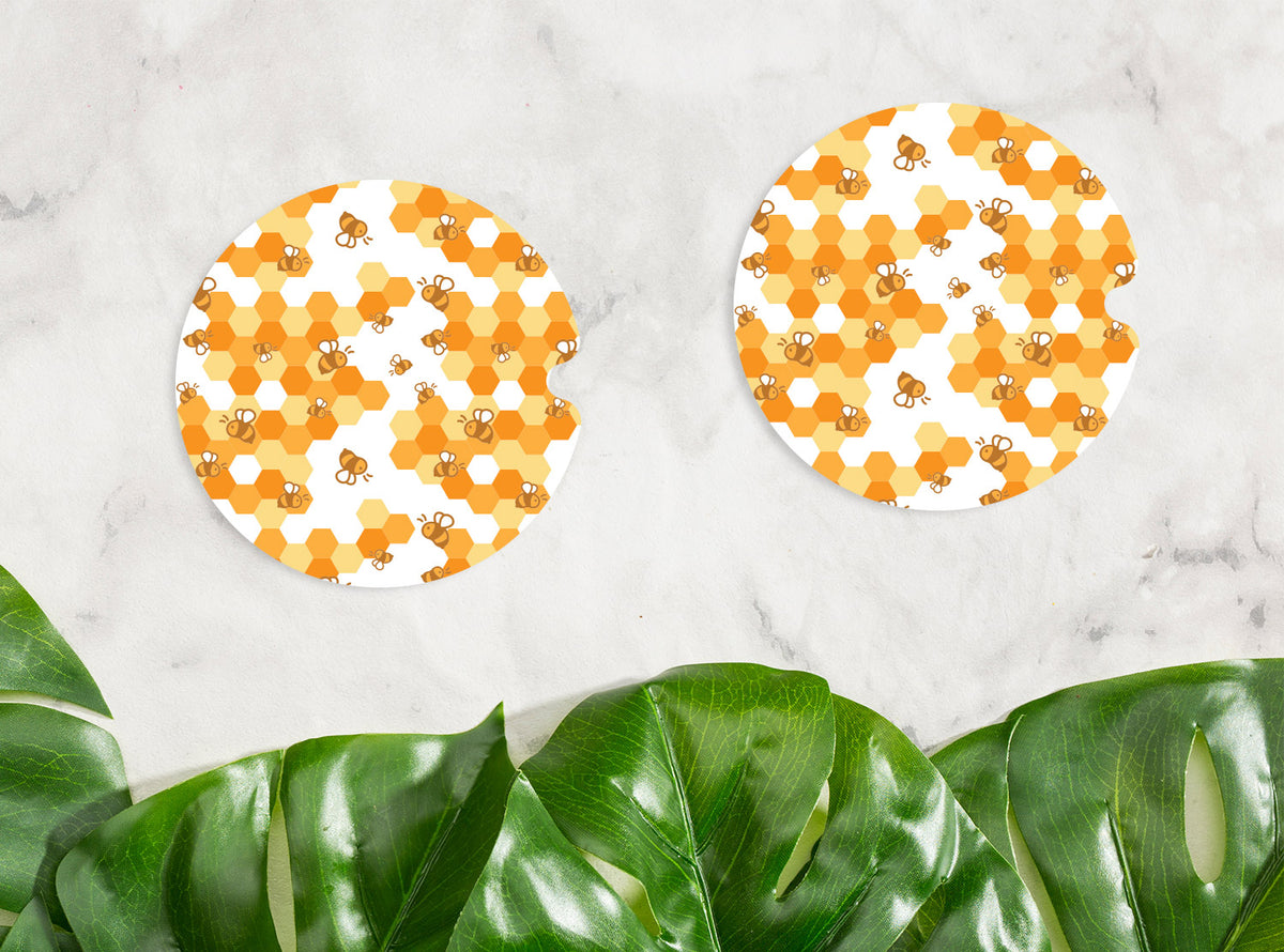 Bee Honeycomb Car Coasters - Femfetti - A set of two printed car coasters with a pattern of bees and honeycomb.