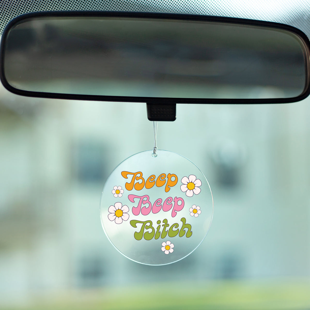 Beep Beep Bitch Rearview Mirror Hang - Femfetti - A clear acrylic circle rearview mirror hang featuring the phrase &quot;beep beep bitch&quot; in a retro font.