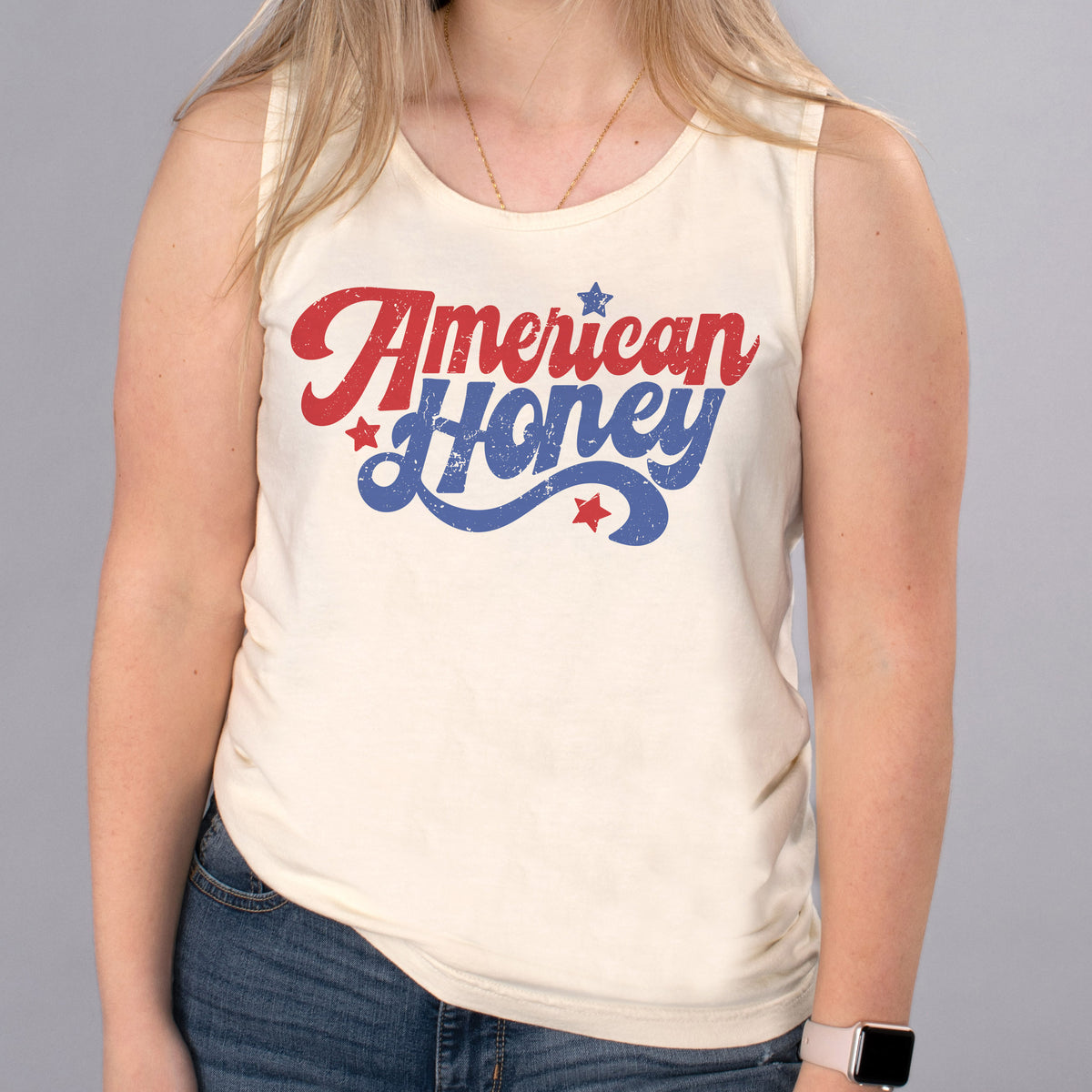 American Honey Tank Top - Femfetti - An ivory color unisex fit graphic tank top featuring the phrase &quot;American Honey&quot; in red and blue retro text.