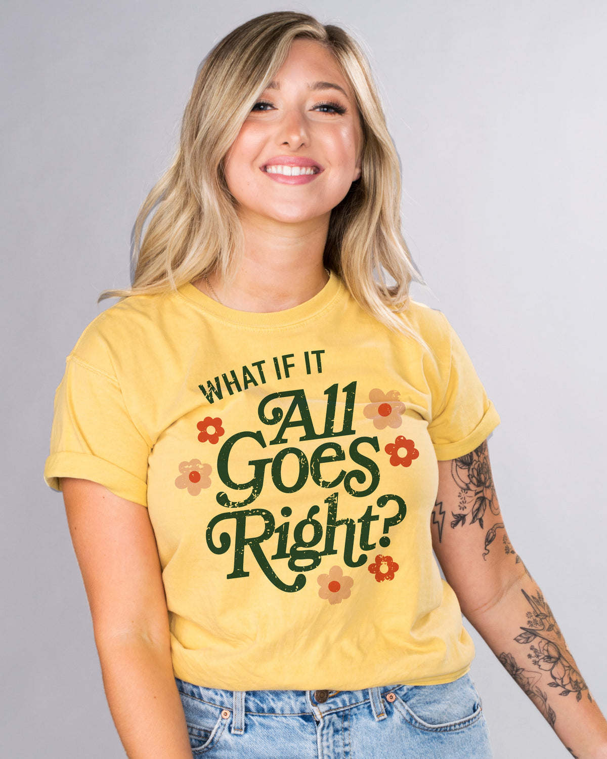 All Goes Right - Femfetti - A mustard color unisex graphic tee with the phrase &quot;What if it all goes right&quot; surrounded by flowers.