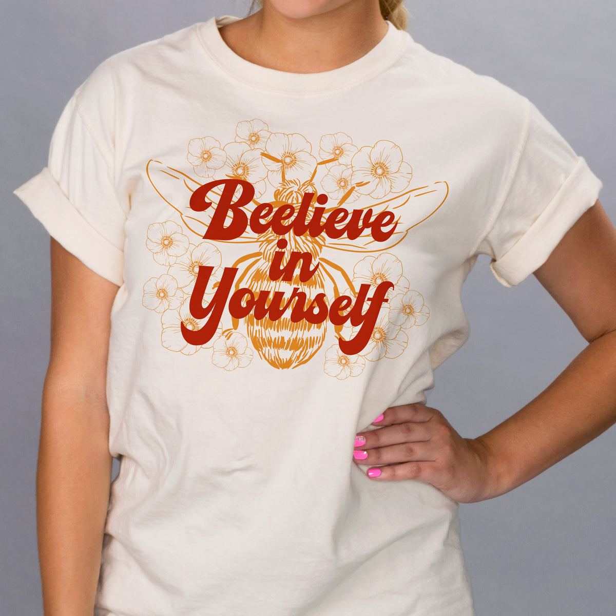 Bee-lieve in Yourself Shirt - Femfetti - An ivory color unisex fit graphic tee featuring the phrase &quot;bee-live in yourself&quot; with the image of a bee.