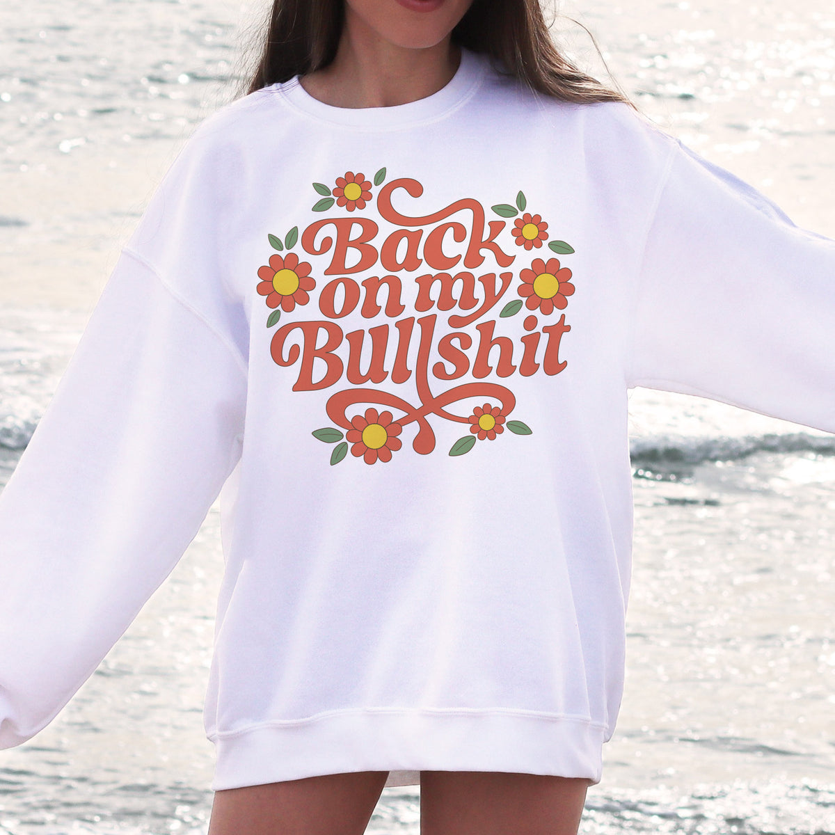 Back On My Bullshit Sweatshirt - Femfetti - A white unisex fit graphic sweatshirt featuring the phrase &quot;back on my bullshit&quot; with flowers.