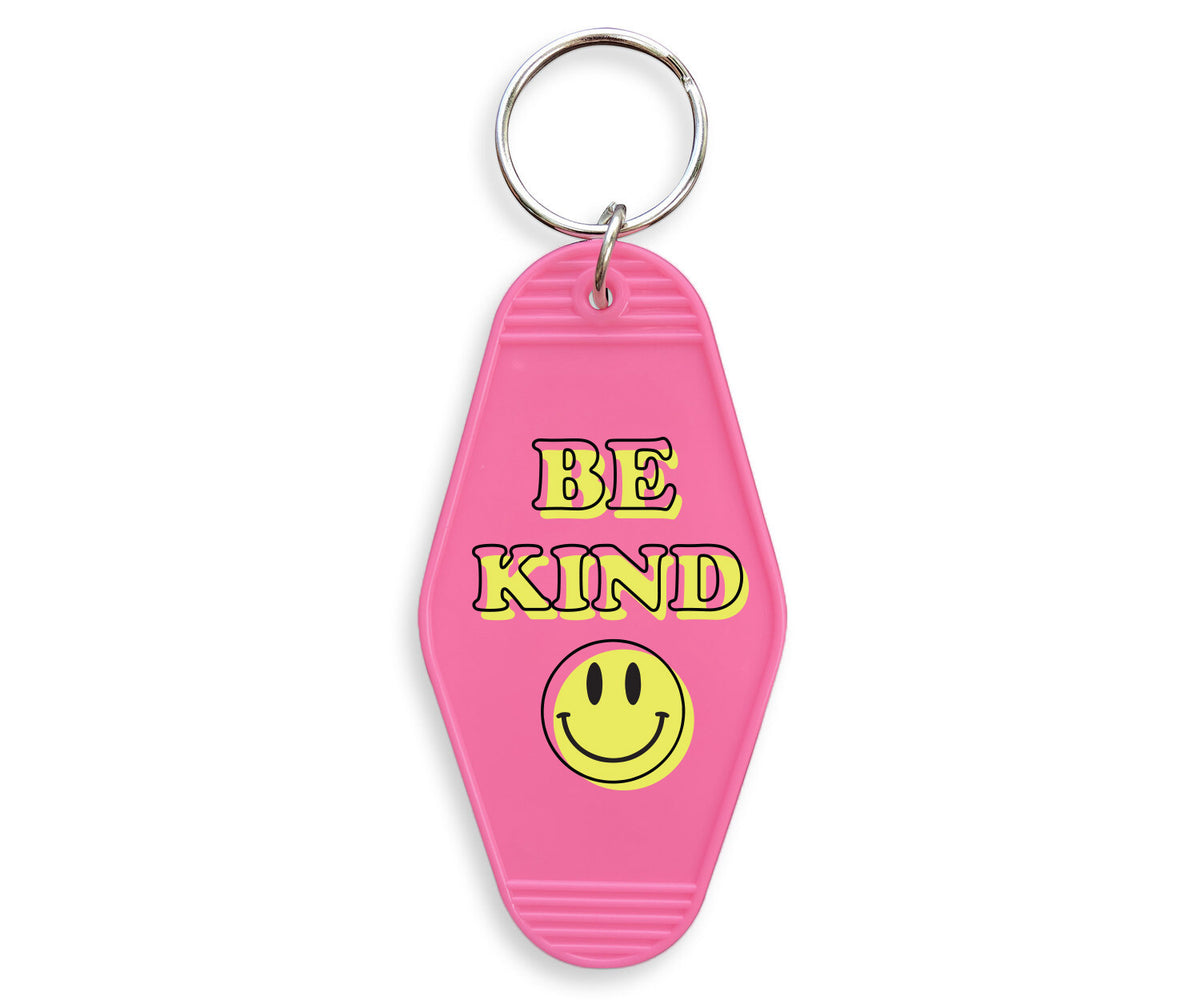 Be Kind Smiley Motel Keychain - Femfetti - A pink acrylic motel style keychain featuring the phrase &quot;Be Kind&quot; with a smiley face.