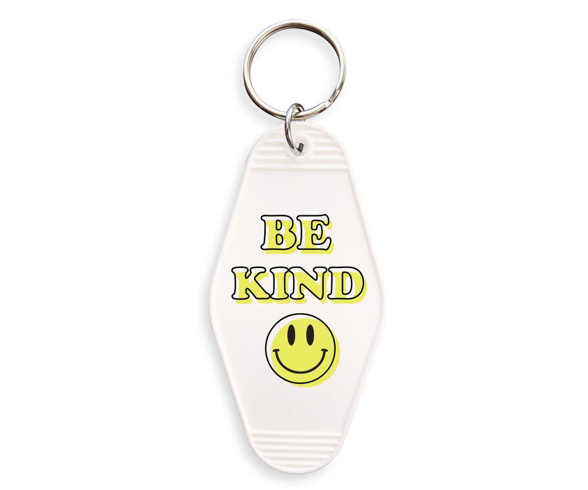 Be Kind Smiley Motel Keychain - Femfetti - A white acrylic motel style keychain featuring the phrase &quot;Be Kind&quot; with a smiley face.