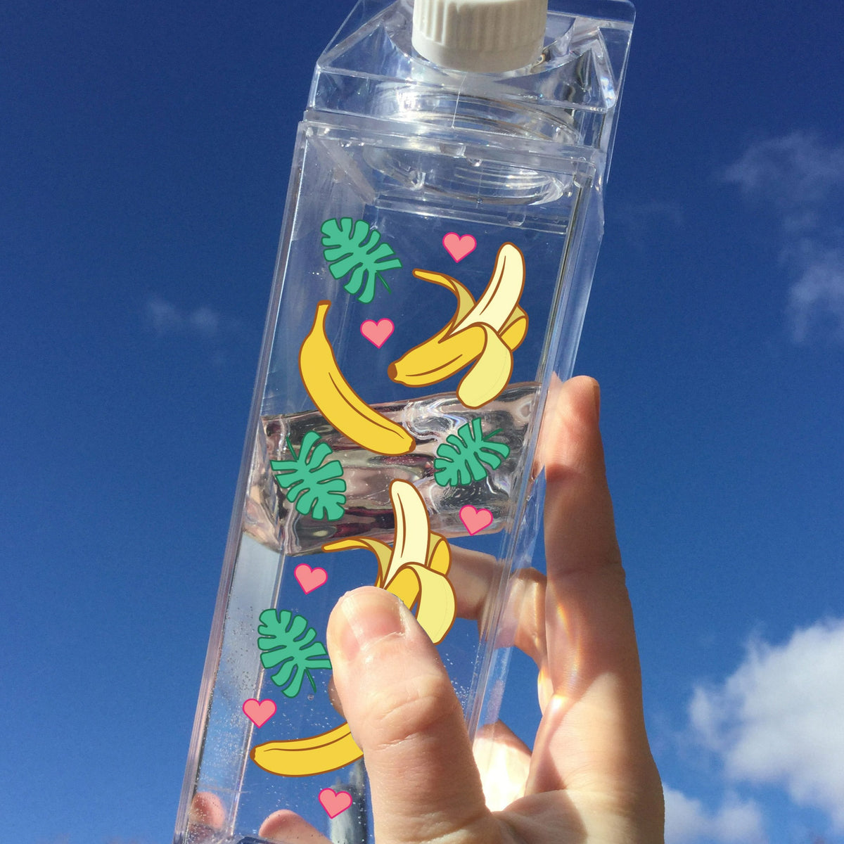 Banana Pattern Milk Carton - Femfetti - A clear acrylic water bottle shaped like a milk carton featuring a pattern of bananas.