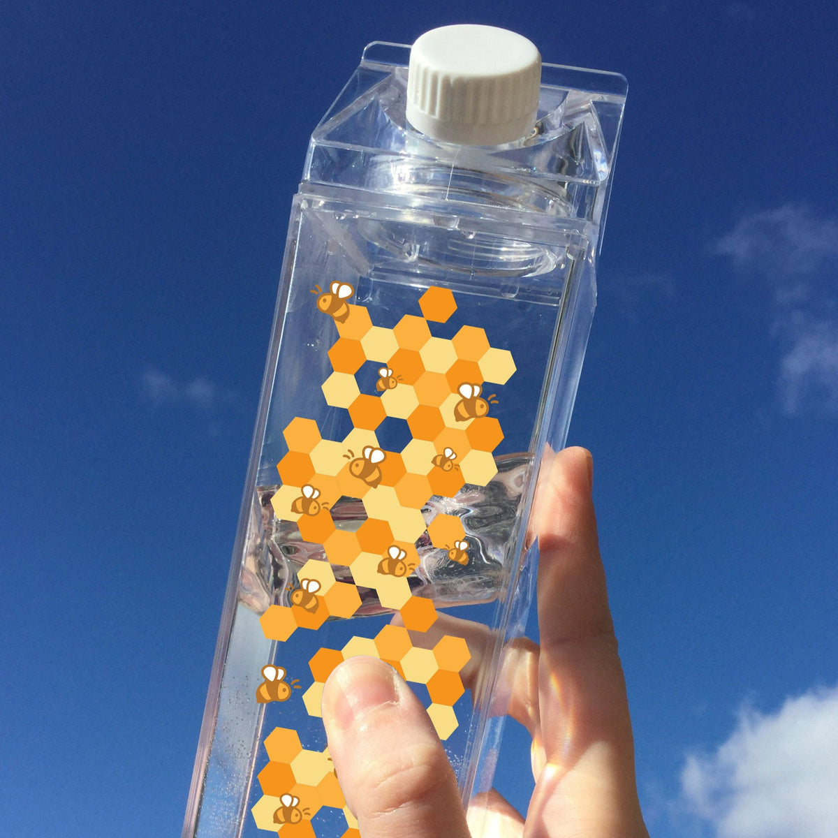 Bee Pattern Milk Carton - Femfetti - A clear milk carton shaped water bottle with a printed pattern of bees and honeycomb.
