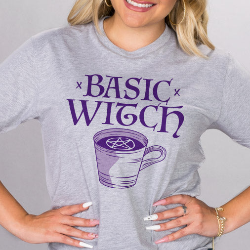 Basic Witch Shirt - Femfetti - A heather gray unisex fit graphic tee featuring the phrase &quot;Basic Witch&quot; in purple text.